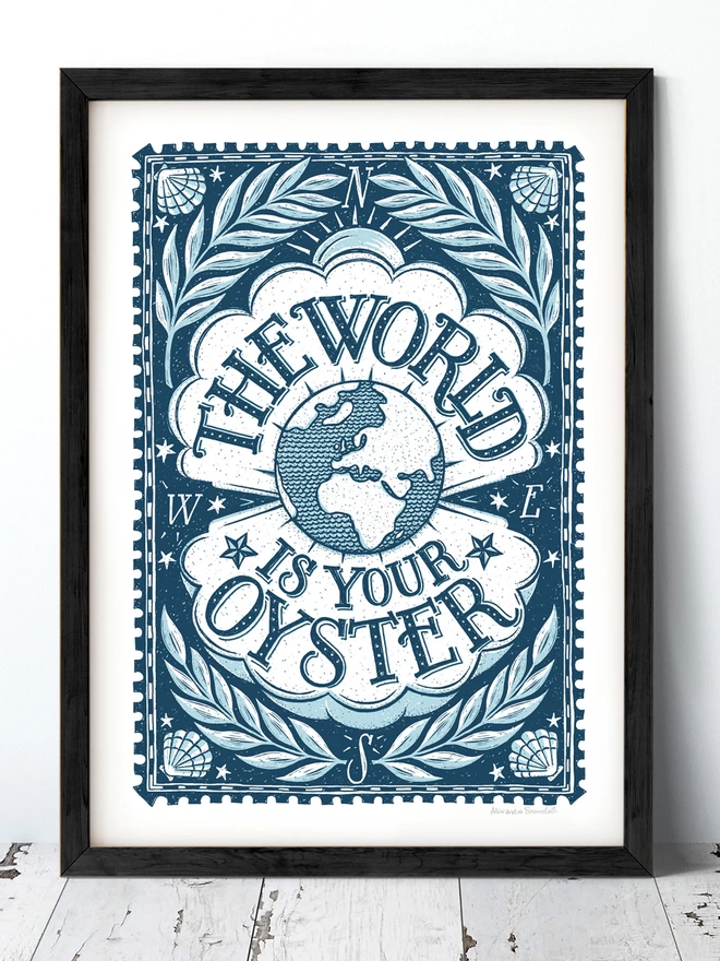 nautical blue world is your oyster print in a black frame on white washed floor