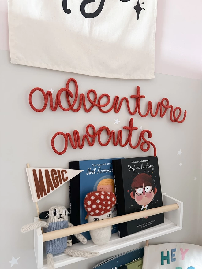 "adventure awaits" wall art decorating a child's playroom space