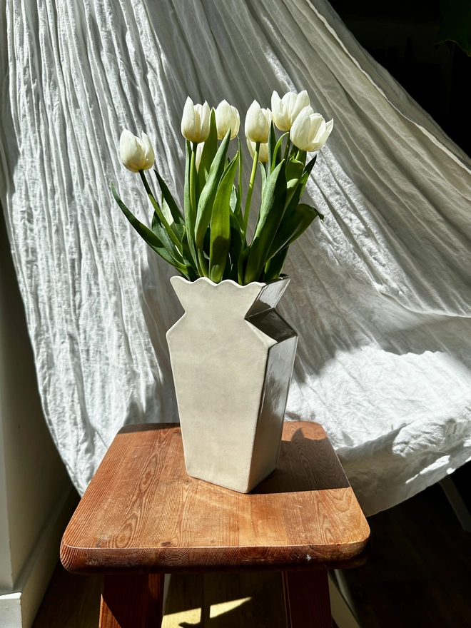 A vase with white tulips
