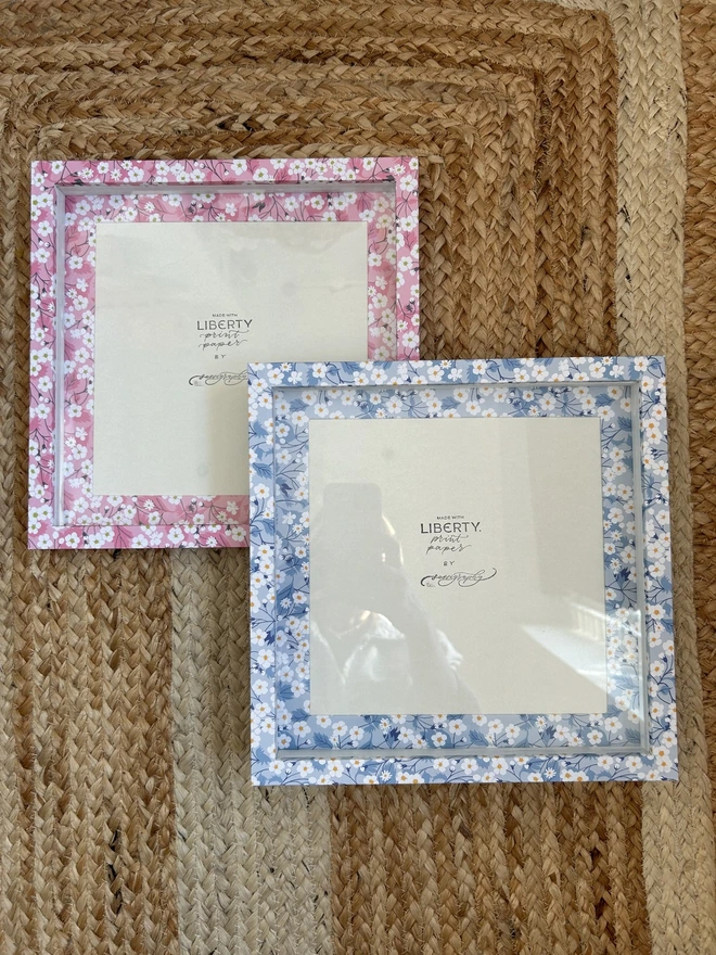 Pair of Liberty paper covered box mount frames in blue and pink floral pattern