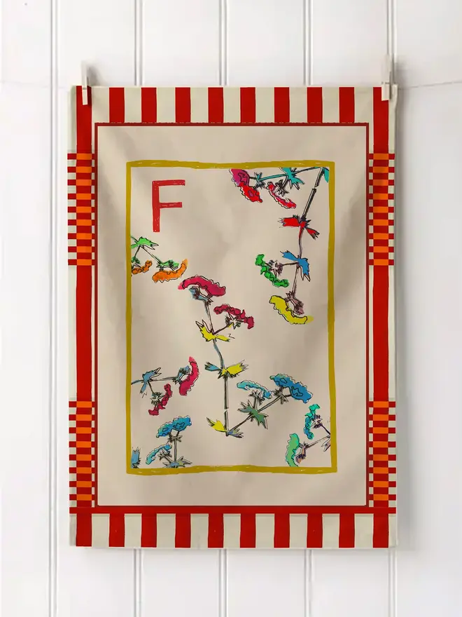 a-z alphabet tea towel. a tea towel with a floral print and the letter 'f' in the corner.