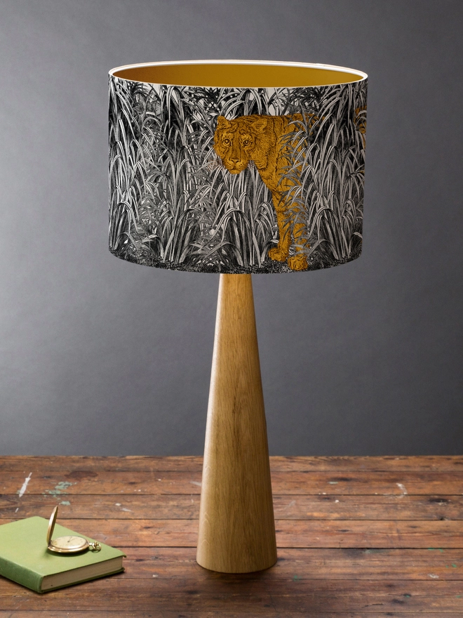 Mountain and Molehill – Tiger in leaves lampshade on base with book on table
