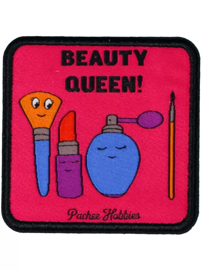 A square pink patch with 'Beauty Queen!' written at the top. Beneath is a smiling brush, lipstick, and perfume bottle.