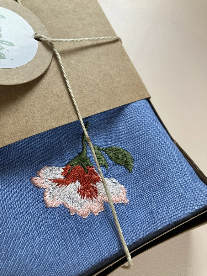 Close up of blue linen napkin in box