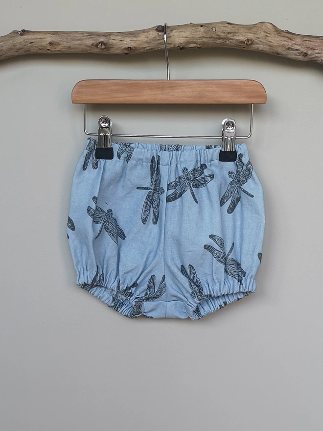 Light Blue Cotton Linen Baby Bloomers. Elasticated waist and leg holes. Featuring a delicate charcoal grey dragonfly print.