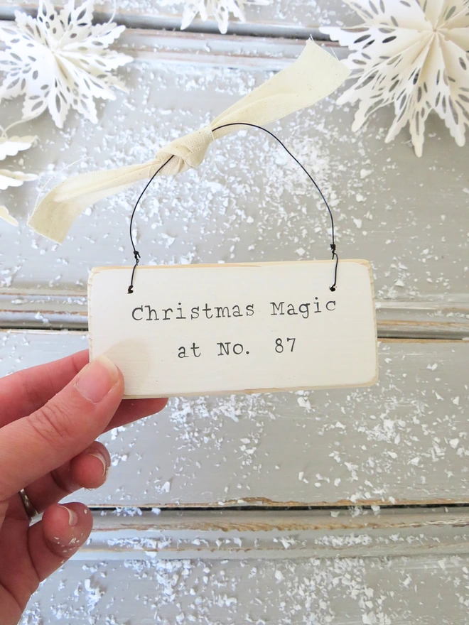Chalky white painted wooden hanging sign with hand painted personalised Christmas Magic message