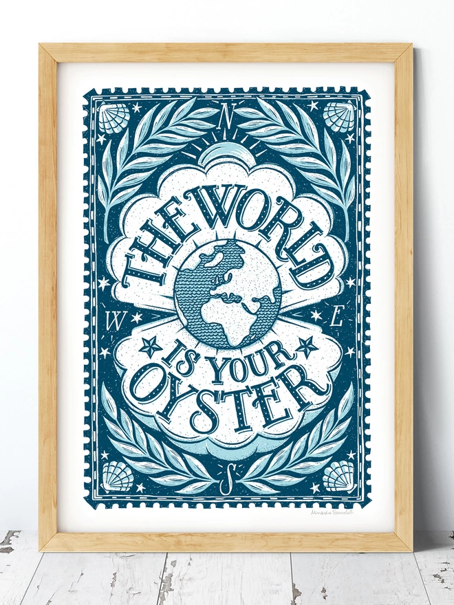 blue and white world is your oyster nautical travel themed print in a wooden frame