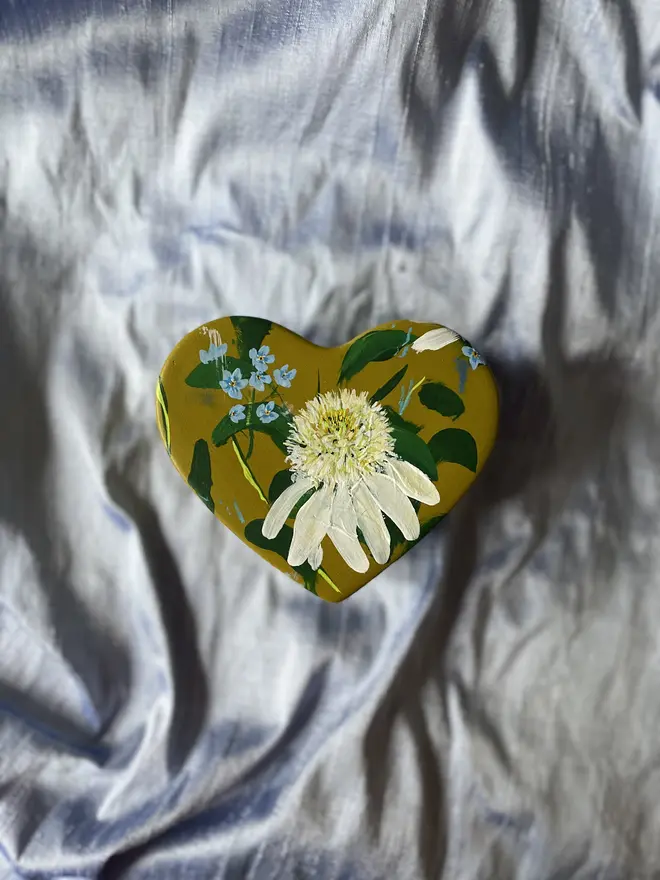 hand painted floral heart shaped keepsake box background in a olive green with white echinaceas and  blue forget me not flowers