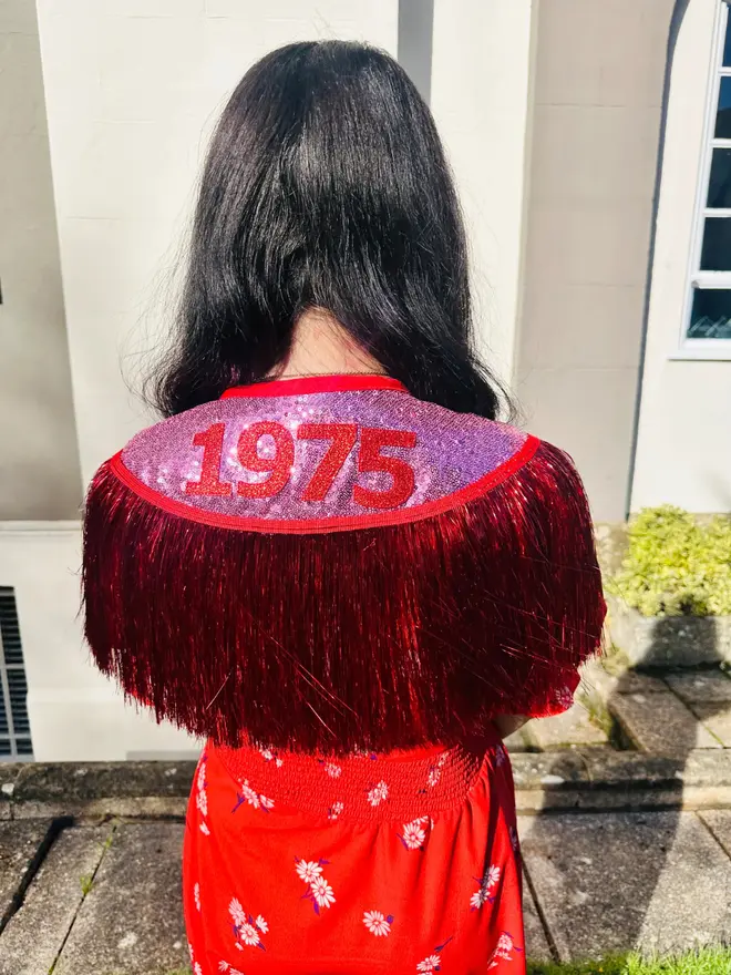 Date of Birth Cape in Red and Pink