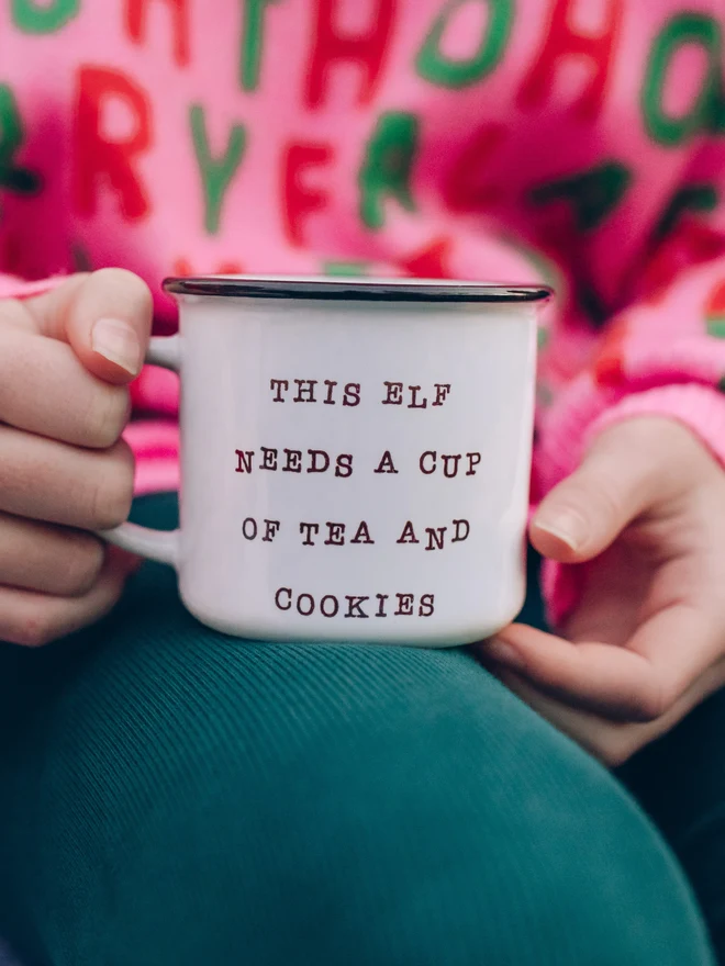 child holding ceramic christmas mug