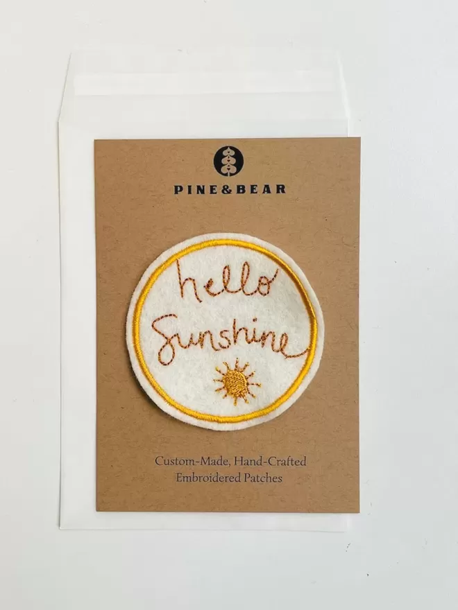 Hello Sunshine embroidered patch on it's presentation card,