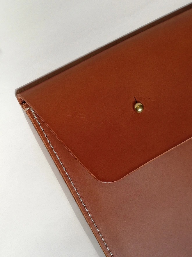 Brown leather document holder with brass fastening 