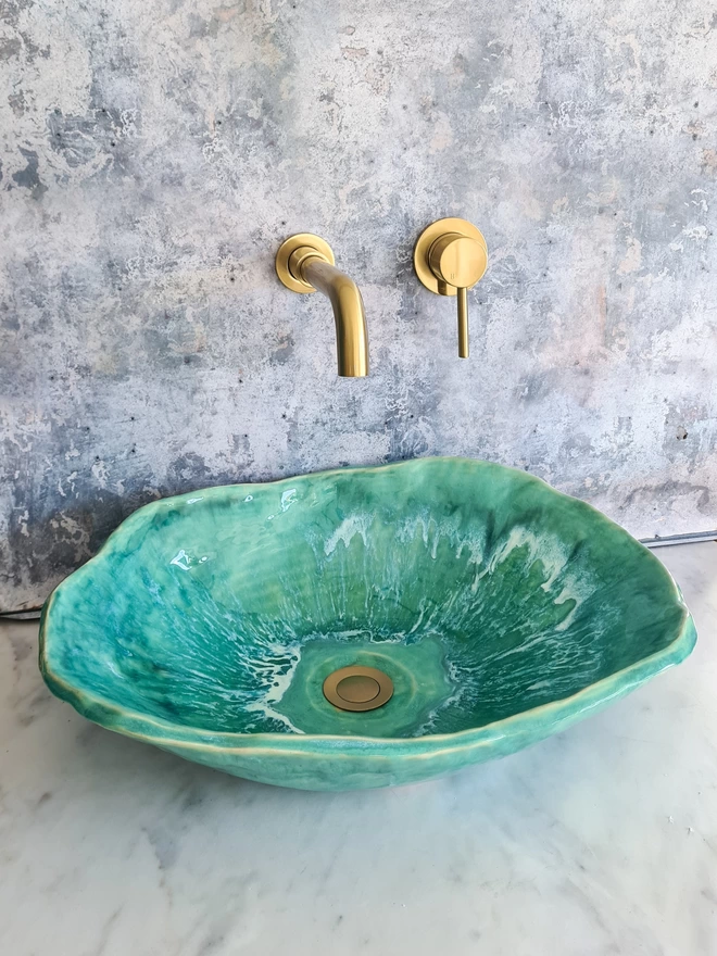 Turquoise green bathroom basin atop a marble countertop with gold taps, bathroom, wc, ensuite, sink, ceramic basin, Jenny Hopps Pottery, J.Hopps Pottery, J.H Pottery, Homeware, Bathroom decor, interior design