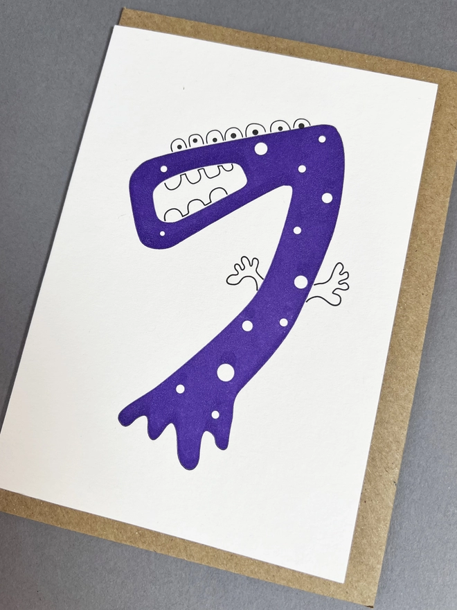 Playfully hand drawn neon purple number seven with envelope for children's party