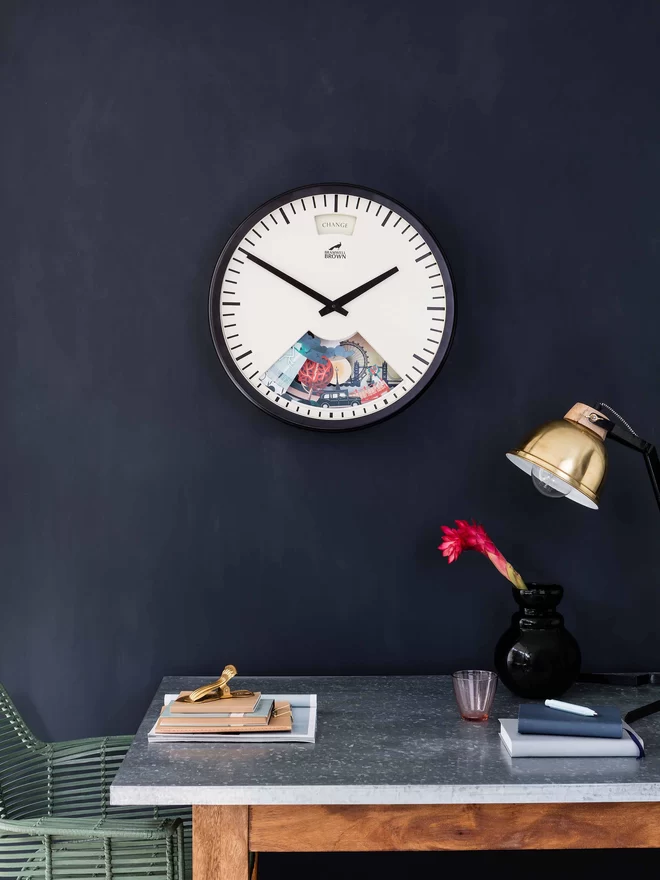 Bramwell Brown Limited Edition London Clock seen on a dark wall.