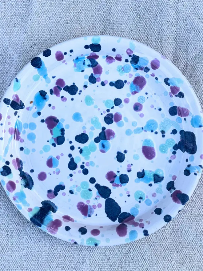 Sweetpea Side Plate, a colourful plate on a stone surface