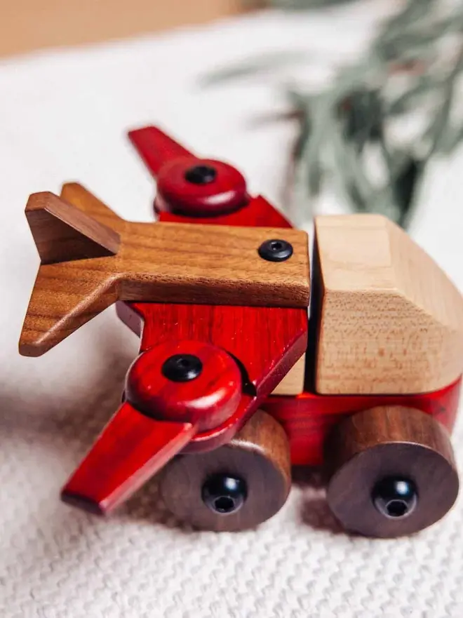 Walnut & Padauk Aeroplane Wood Heirloom Toy, on a table. 