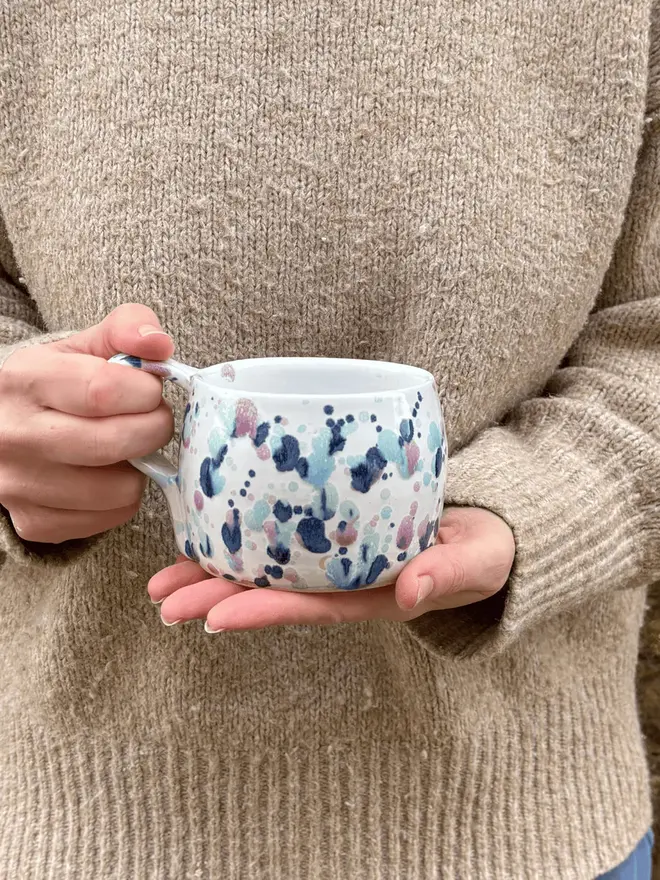 Sweetpea Large Round Mug, a woman holding a colourful mug in front of them. 