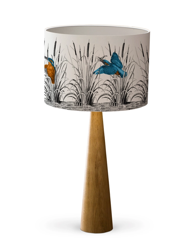 Handmade lampshade featuring vibrant kingfishers among bulrushes in a whimsical countryside-inspired design, combining nature, colour, and artisan style.