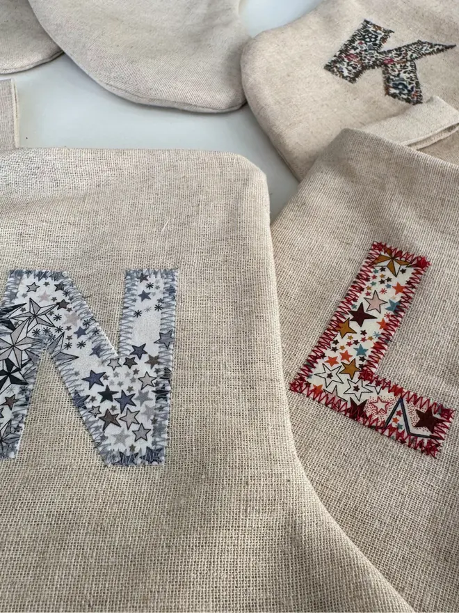 Floral Linen Christmas Stocking. Letters L & N on a mini stocking with star pattern