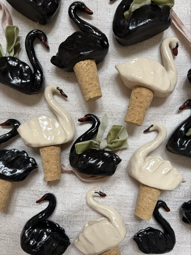 Hand sculpted ceramic Swan Bottle Stoppers and ceramic swan ornaments. 
