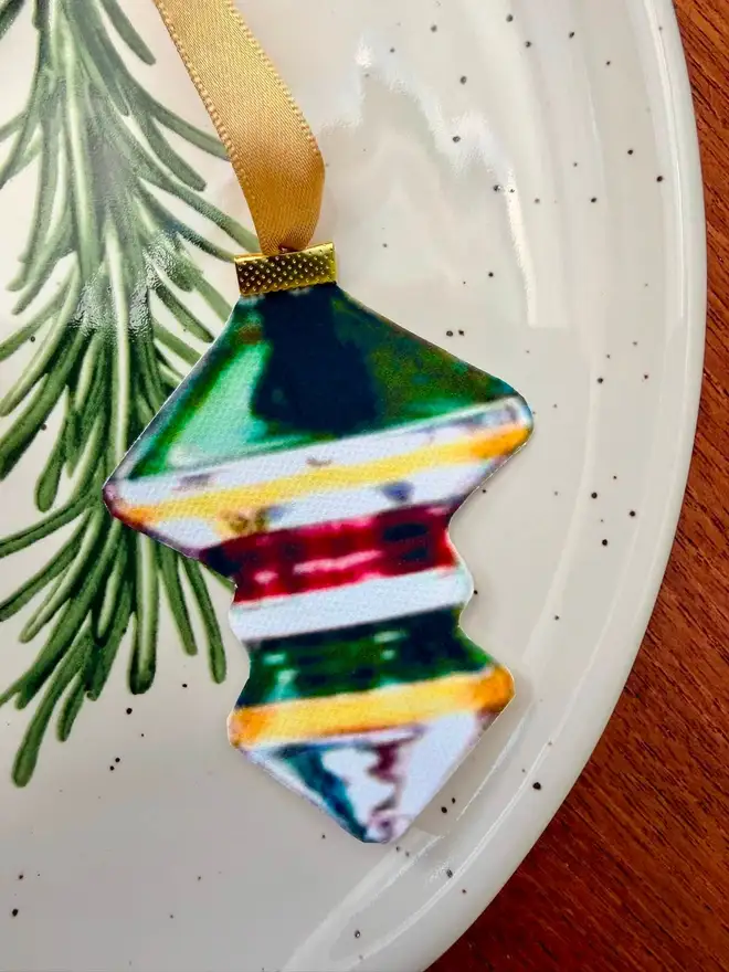 A vintage bauble shaped napkin tie with gold ribbon