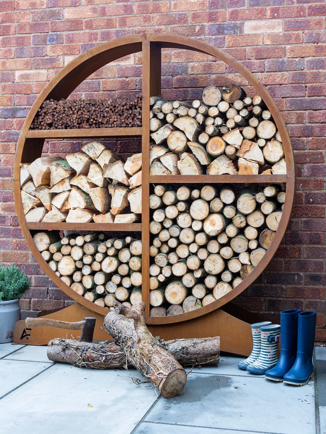 Oakham Log Store, log Store filled with wood stacked in the garden