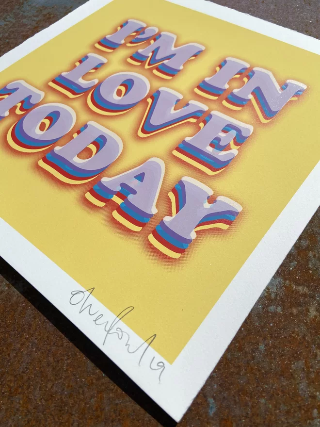 "I'm In Love Today" Hand Pulled Screen Print with deckled edges yellow background and the words I’m in love today printed on top in white with rainbow shading 