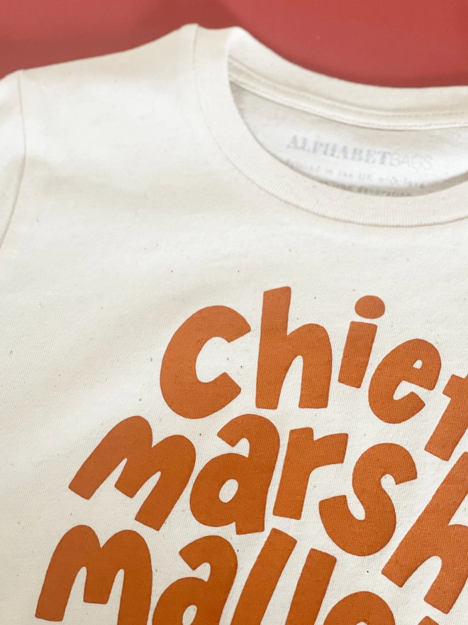 Close up of the flecked cotton of the chief marshmallow toaster organic cotton kid's t-shirt 