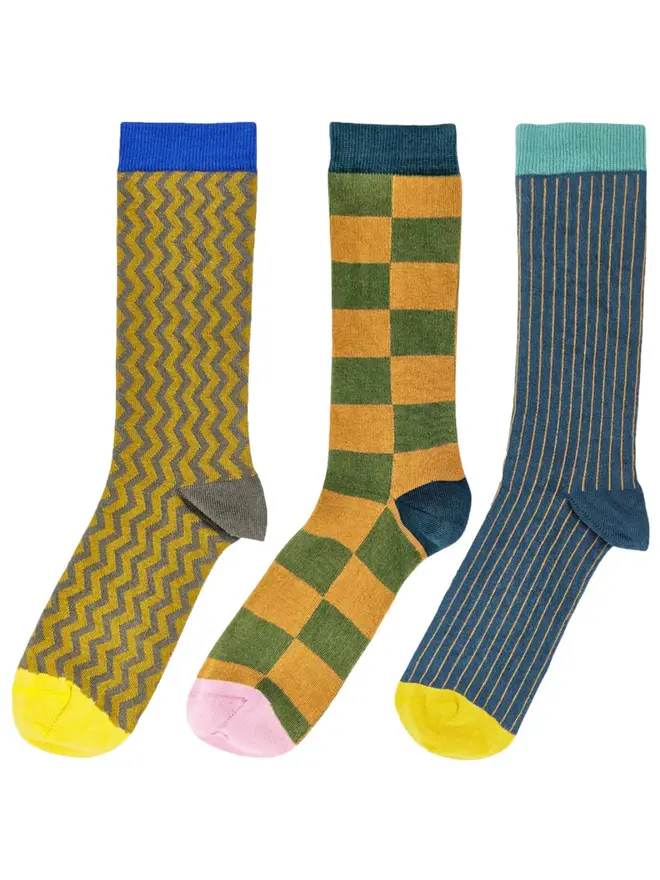 Men's Organic Cotton Ankle Socks Packs (Sets Of 3), a set of colourful patterned socks sitting on a plain white surface. 