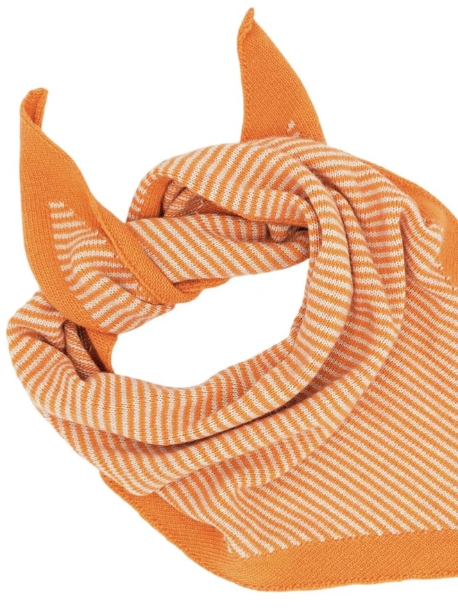 Lambswool Triangle Neck Scarf, a colourful neck scarf sitting on a white plain surface. 