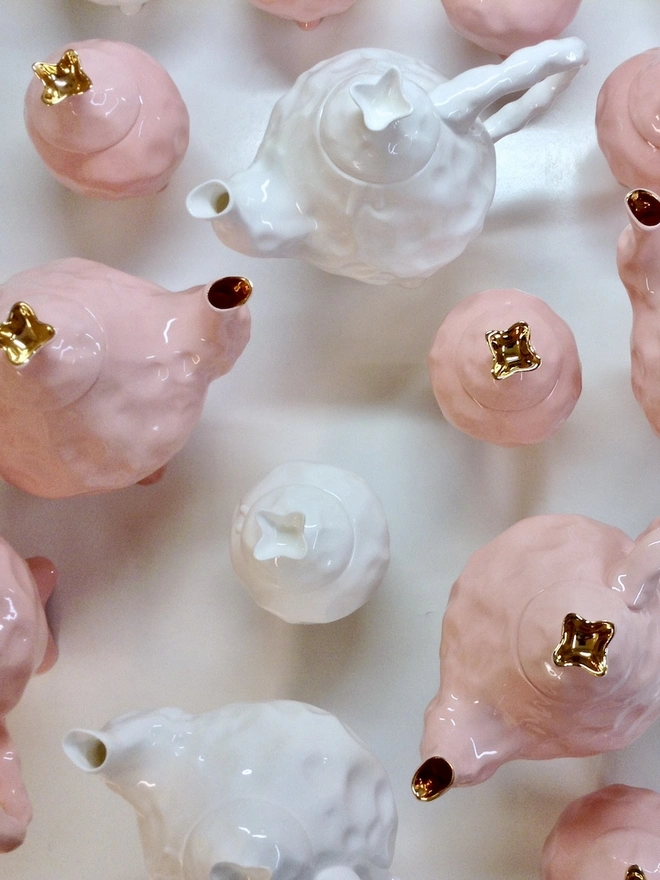 Pink and White Sugar Bowls And Teapots