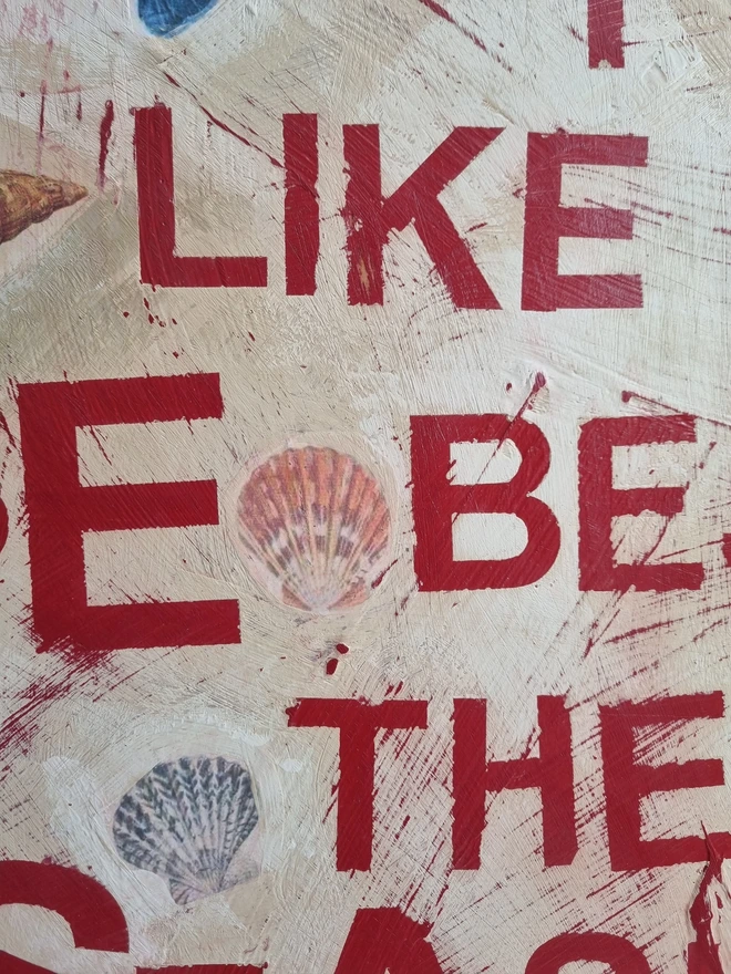An art panel made from a collage of antique botanical sea creature images in a limited palette of blues, reds browns and pinks on a cream textured background with text in red that reads 'oh I do like to be beside the seaside'.