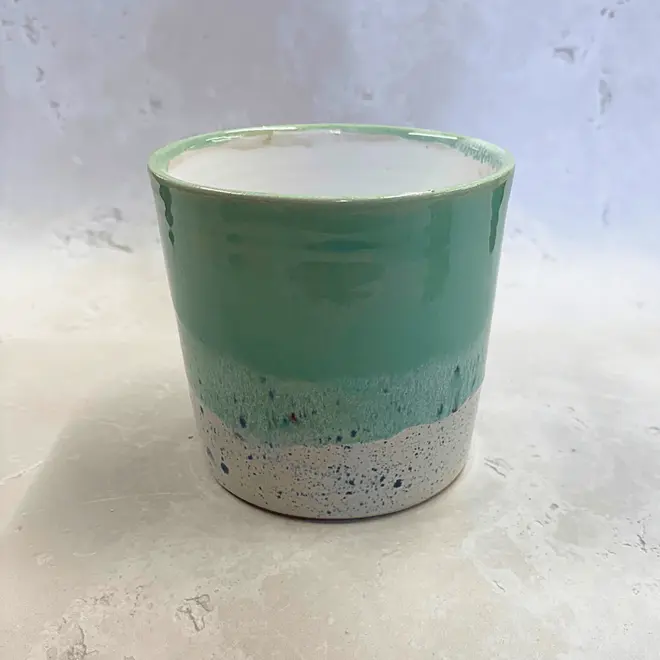 Shoreline Large Pot, a colourful pot placed on a stone surface. 