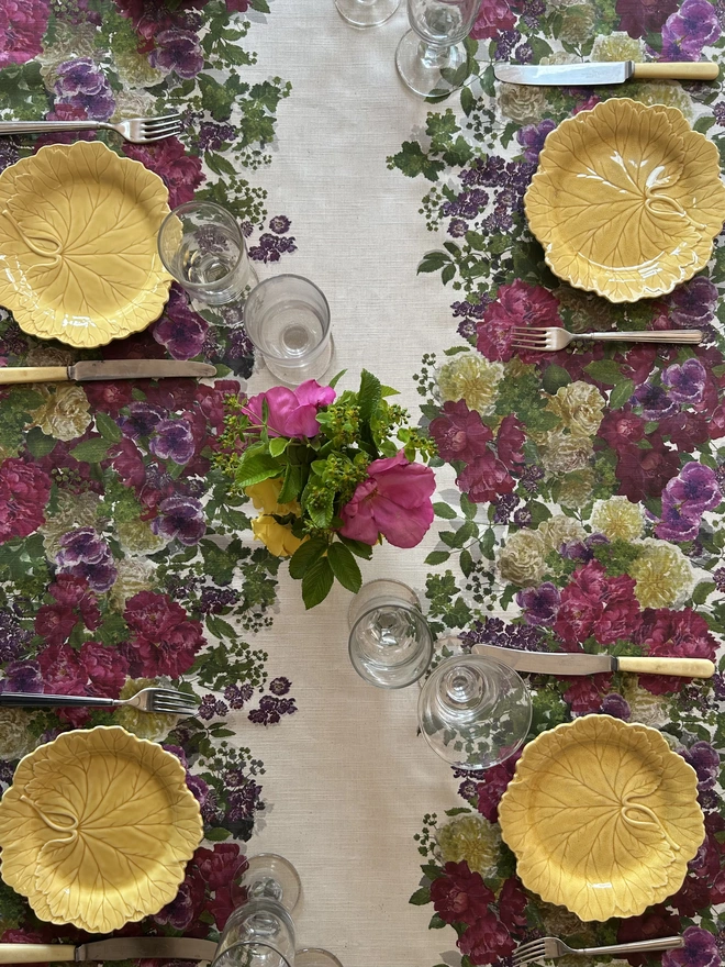 Floral summer tablecloth covered in two hand painted garlands of roses