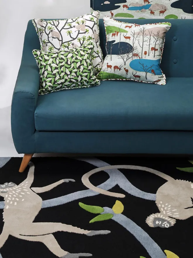 Langur Hand Tufted Rug, a monkey design rug sitting in living room with a sofa and patterned cushions.