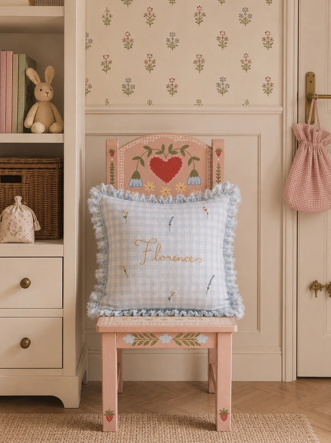 Blue gingham hand embroidered pillow on children’s hand painted chair