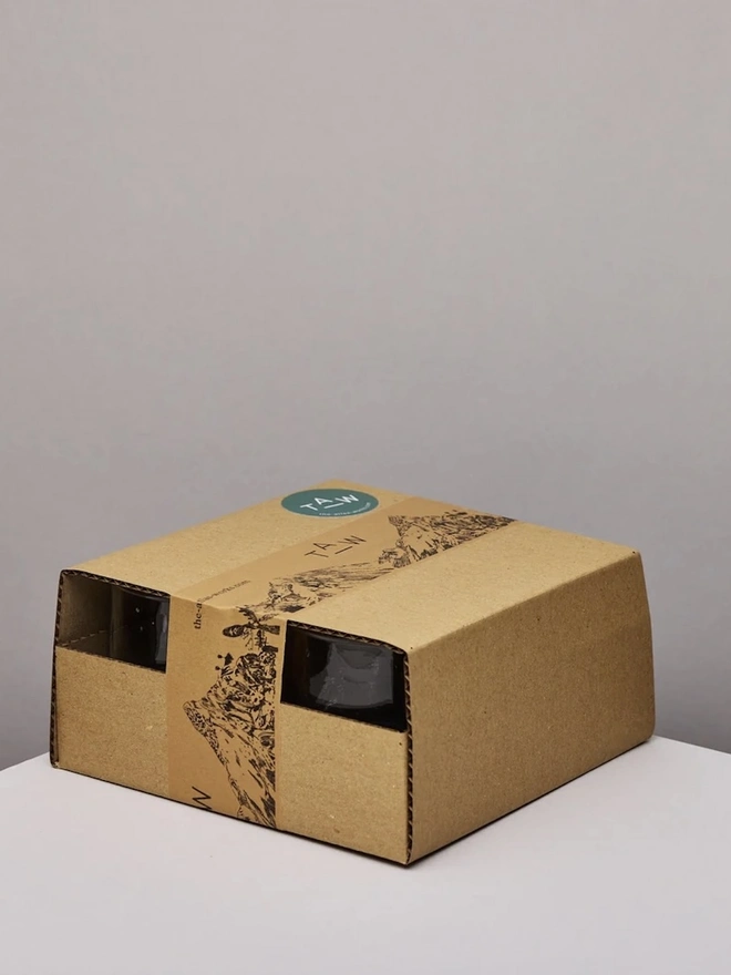 Low Wine Glasses (Set Of 1 Or 4), a group of wine glasses sitting on a plain counter top against a white backdrop. They are packaged together. 