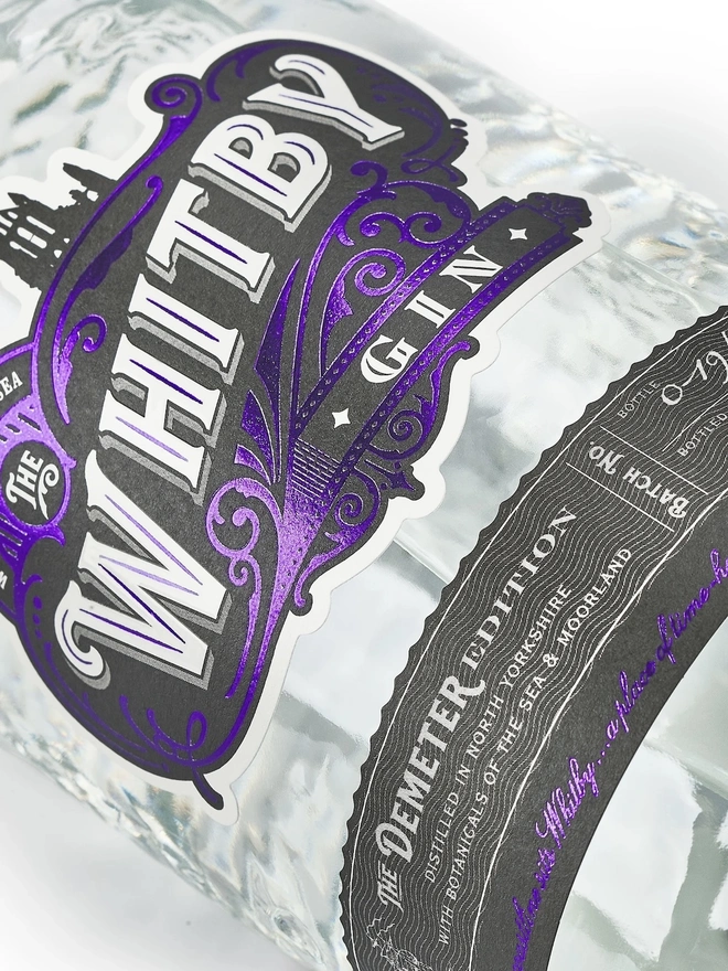 The Demeter Edition Gin, a bottle of gin sitting on a plain white surface. 