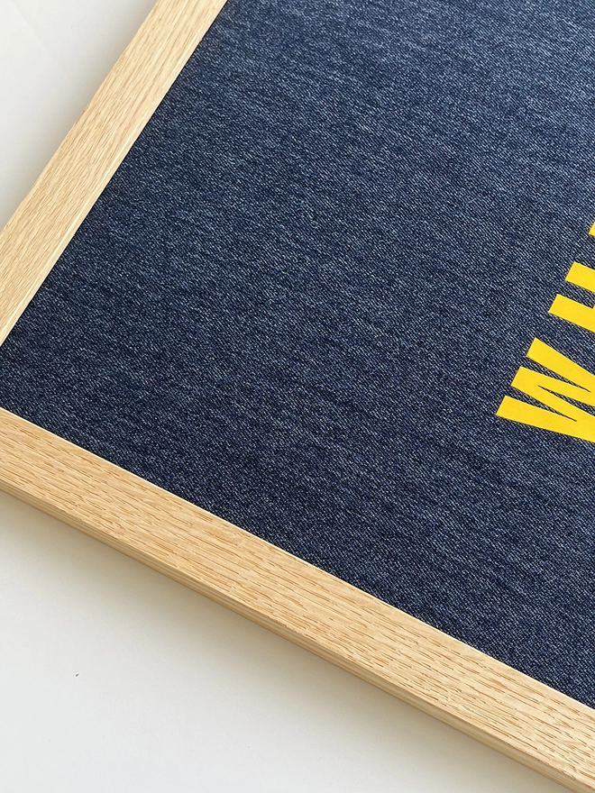 Denim with yellow quote framed print - corner close up