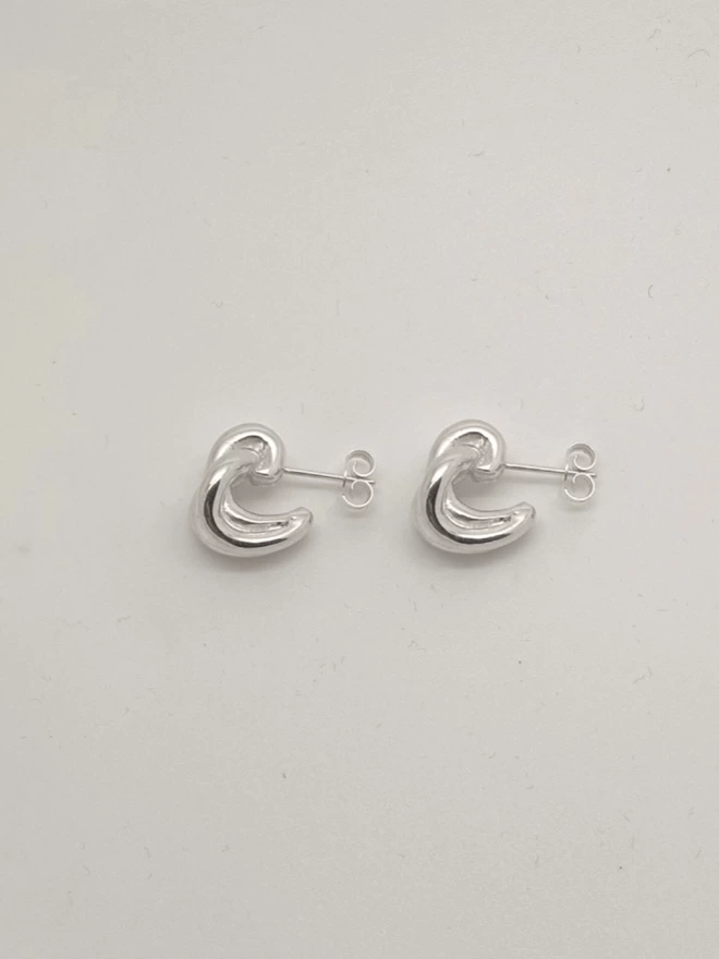 chunky silver ear huggers with a twisted design