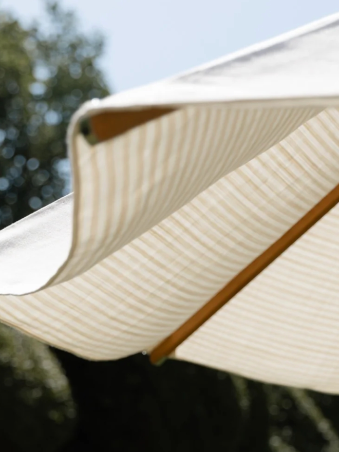 Beige & White Striped Parasol. A white, striped parasol.