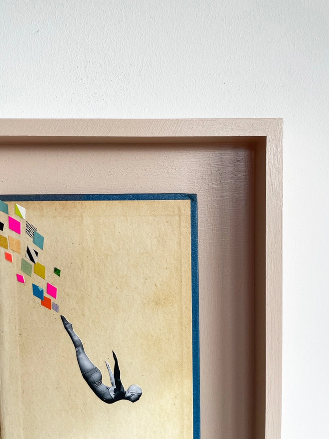 A female swimmer performs the perfect swan dive into the swimming pool below. A framed collage made with vintage papers and pops of neon pink with torn edges and interesting textures.