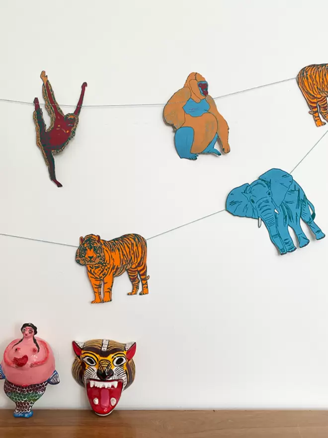 Jungle animal shapes with wooden figurines in foreground