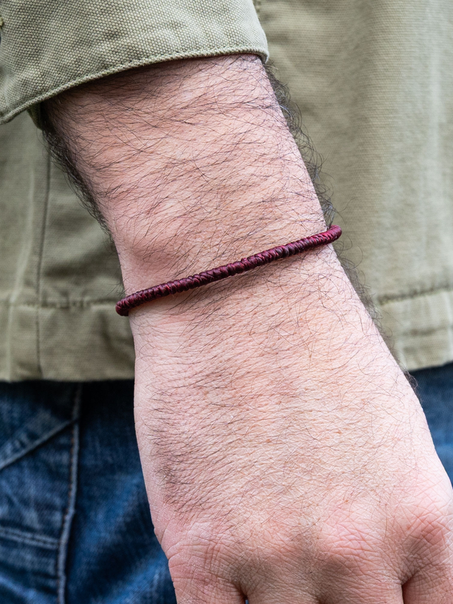 men red cord bracelet