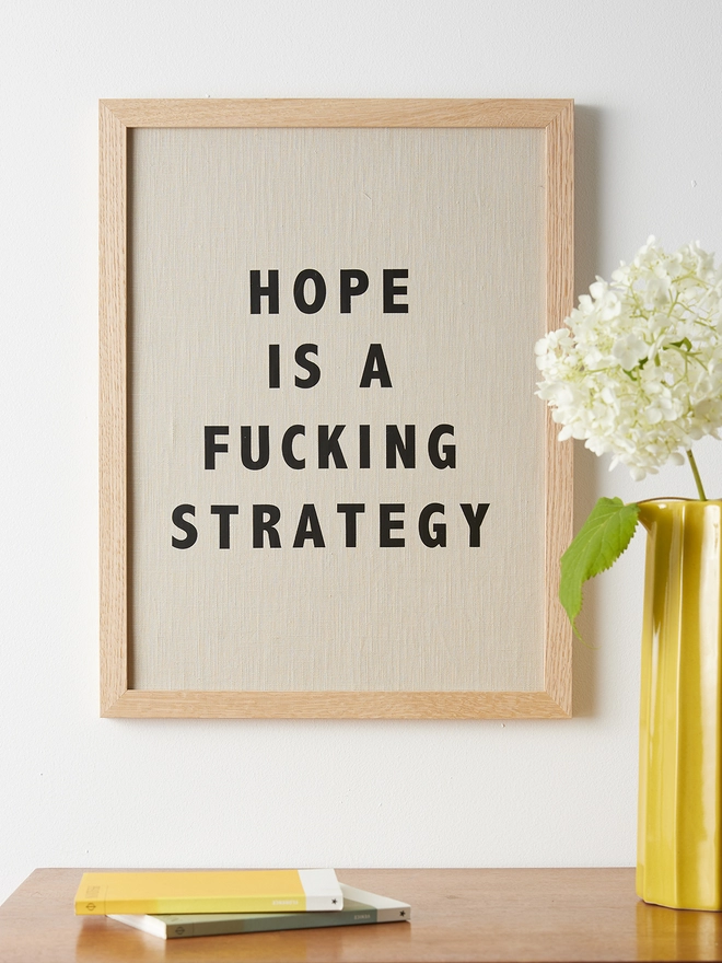 Hope is a fucking strategy natural linen print with black typography