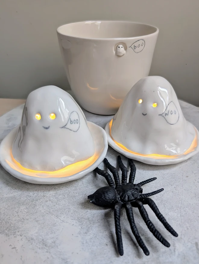 ceramic cup with tiny ghost and two ceramic ghosts tealights with speech bubbles with the words boo and woo