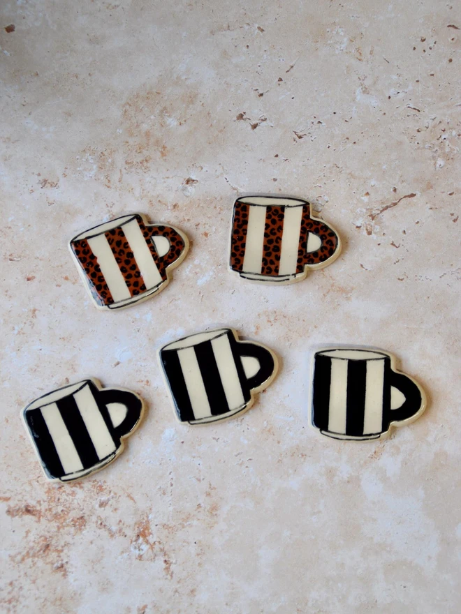 Handmade ceramic mug magnets — black and cream striped design