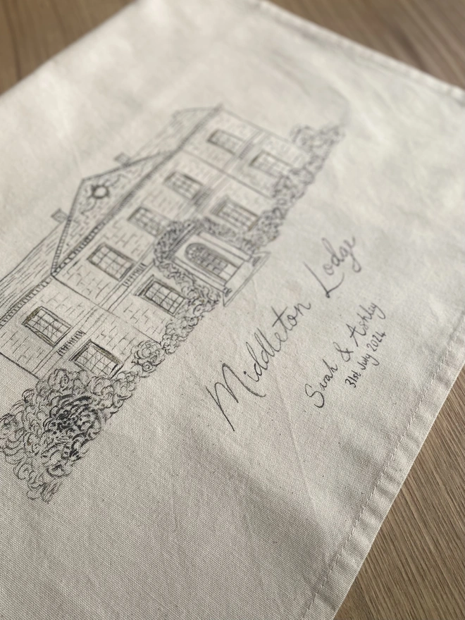 Tea towel with a hand painted venue illustration 