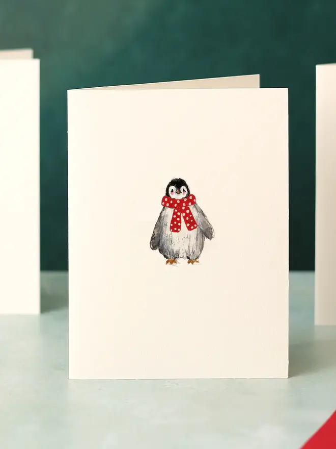 illustrated penguin with red scarf christmas card